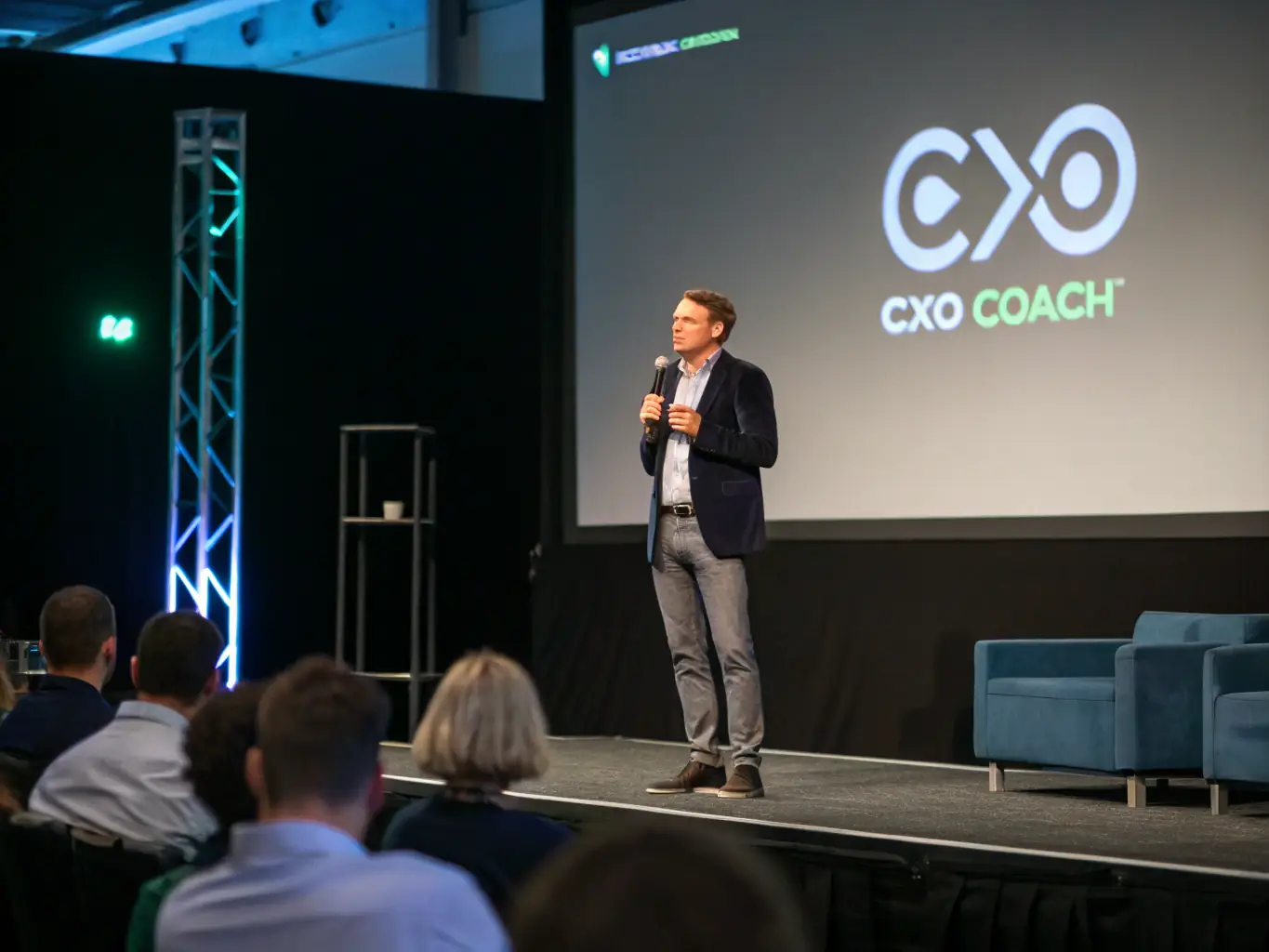 An image of a confident business leader speaking at a seminar with an engaged audience, representing the Leadership Development Program.